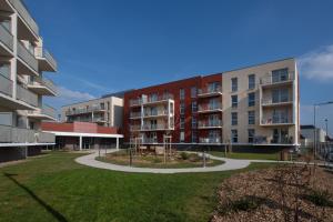 an apartment complex with a park in front of it at DOMITYS LES CERNEAUX in Hazebrouck