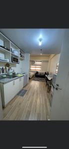 a room with a kitchen and a living room at Khentdrick's Place at Holland Park Southwoods in Biñan