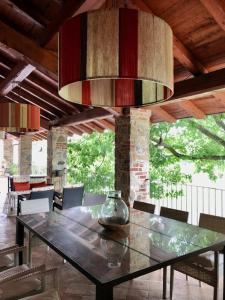 a dining room table with a vase on top of it at Tenuta La Quassa in Ispra
