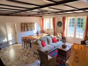 a living room with a couch and a table at Manoir Petit Meysset in Sarlat-la-Canéda