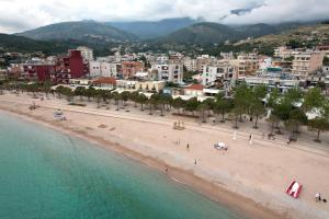 an aerial view of a beach with buildings and a city at Mema Rooms in Himare