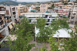 an aerial view of a city with buildings and trees at Mema Rooms in Himare