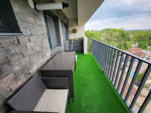 a balcony with a table and chairs and green grass at DeLux Apartments with Terassa in Towers Ever Green in Iaşi