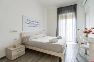 a small bedroom with a bed and a desk at Ammare Bed & Breakfast in Marina di Camerota