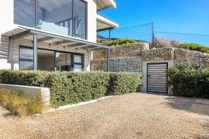 a house with a fence and a garage at Stonehurst Views - 1 Bed Flatlet in Cape Town