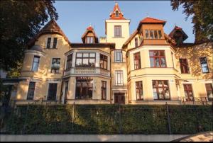 a large white house with a clock tower at The Tiny Space 6m2 with private bathroom in the hallway in Sopot