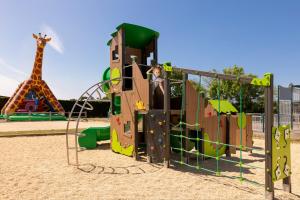 a playground with a slide and a giraffe in the background at Camping Park Er Lann in Saint-Pierre-Quiberon