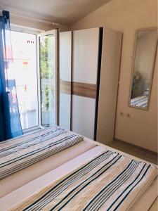 a bedroom with a bed with a large window at Guest House Jadro in Rovinj