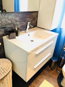 a bathroom with a white sink and a mirror at Guest House Jadro in Rovinj