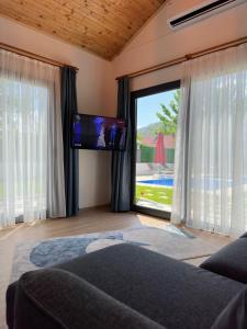 a living room with a couch and a large window at Sea Life Homes in Kemer