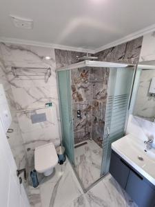 a bathroom with a shower and a toilet and a sink at Royal Homes 501 in Antalya