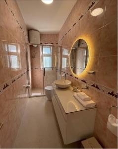 a bathroom with a sink and a mirror at Villa Grigor in Berat