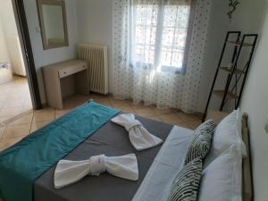 a bedroom with a bed with two bow ties on it at Ioanna's Apartment in Potamia