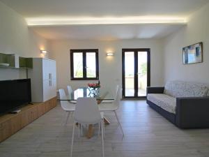 a living room with a table and a couch at Apartment in Costa Rei in Monte Nai