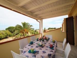 a table on the balcony with a view of the desert at Apartment in Costa Rei in Monte Nai