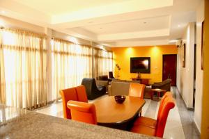 a living room with a table and chairs at La Cour Hotels and Apartments Cooper in Lagos