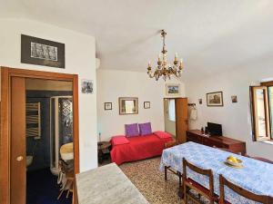 a living room with a red bed and a table at Ellera Suite con Parcheggio Privato - Albisola Superiore in Stella
