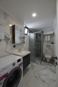 a bathroom with a washing machine and a sink at Royal Homes 502 in Antalya