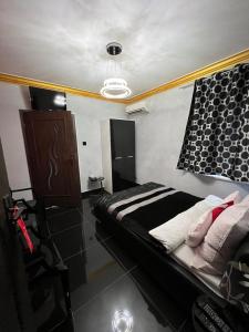 a bedroom with a bed and a chandelier at Apartamenty Południe BB Rico in Bielsko-Biala +3 photos