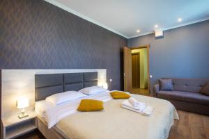 a bedroom with a large bed with towels on it at Hotel Terrace Kutaisi in Kutaisi