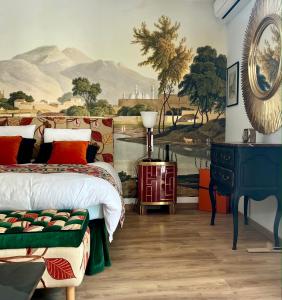 a bedroom with a bed and a painting on the wall at Villa Pauline in Avignon