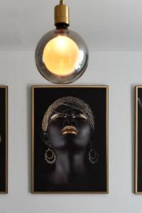 a picture of a black woman with a light fixture at New apt in Dubai Marina with balcony and sea view in Dubai