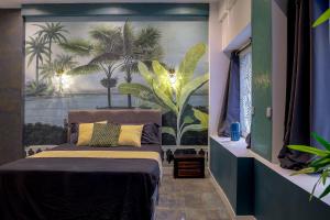 a bedroom with a large mural of palm trees at Jacuzzi, Mer 3 min, B&B in Nice