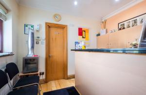 a room with a bar with chairs and a stove at The Brent Hotel - London - Wembley in London