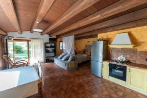 a kitchen with a refrigerator and a living room at il Gelso Nero in Ancona