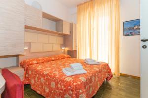 Llit o llits en una habitació de Hotel Croce Del Sud