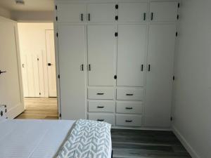 a bedroom with white cabinets and a bed at North End Bungalow 1921 Half in Boise