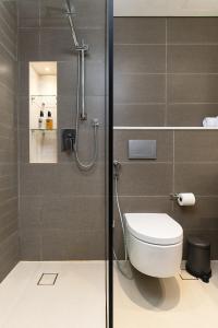 a bathroom with a toilet and a shower at New apt in Dubai Marina with balcony and sea view in Dubai