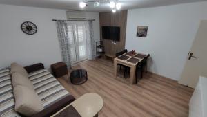 a living room with a couch and a table at ADRIATIC APARTMENT center II MAKARSKA in Makarska