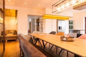 a dining room with a wooden table and chairs at Chalet Murmi in Uttendorf