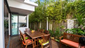 a patio with a wooden table and chairs on a deck at Hapier Villa in Nha Trang