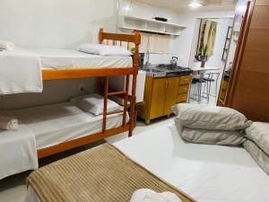 Habitación con 2 literas y cocina. en Residenciais Maria Flor, en Gramado