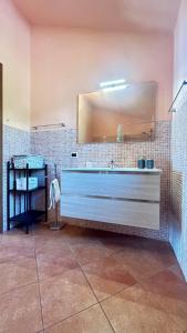 a bathroom with a large mirror and a sink at Agriturismo Azzurra Biricchina in Riva Ligure