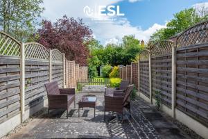 a row of chairs in a garden with fences at Cute & Cool Two Bed Townhouse with Garden & Parking in Shrewsbury