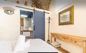 a bedroom with a bed and a blue door at Napoleon with rooftop terrace in Acre