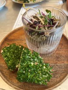 a plate of food with a salad and a glass bowl at Appartments Am Bach in Gerlos