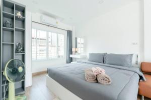 two towels on a bed in a bedroom at White House Apartment - Chalong in Chalong 