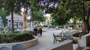 a group of people sitting at tables in a park at ADRIATIC APARTMENT center II MAKARSKA in Makarska