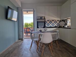 una cucina e una sala da pranzo con tavolo e sedie di Maison Costa del Sol - Capitolo, Monopoli a Monopoli
