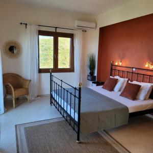 a bedroom with a large bed and a window at Villa Farangi in Gállos