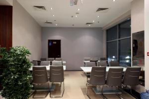 a conference room with a table and chairs at MRA Grand Hotel in Dubai