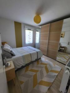 a bedroom with a large bed and a room with at Superbe T3 Chessy Disney/Paris - Jacuzzi, Jardin, Barbecue, Parking in Chessy