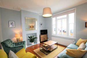 a living room with a couch and a table at Lovely 2BR home with sunny garden in Montpelier in Bristol