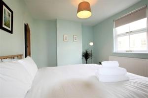 a bedroom with a white bed and a window at Lovely 2BR home with sunny garden in Montpelier in Bristol