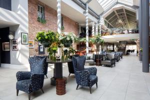 a dining room with chairs and a table with flowers at Lyrath Estate in Kilkenny