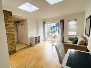 a living room with a couch and a table at Perfect Location Whole Apartment With Wifi & Private Garden CONTRACTORS WELCOME in Southend-on-Sea